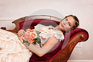 Victorian woman with flowers on fainting couch photo