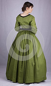 Victorian woman in a green bodice and skirt