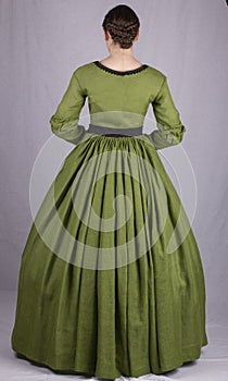 Victorian woman in a green bodice and skirt