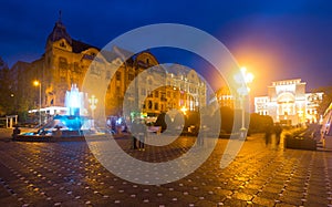 Victoriei Square with colored fountain and National Opera