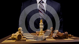 Victorious Business Leader in Suit Pounds King Chess Piece on Wooden Game Board