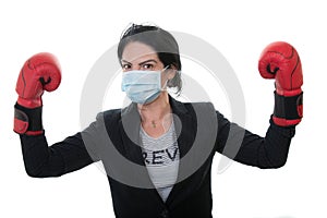 Victorious business woman with boxing gloves and mask