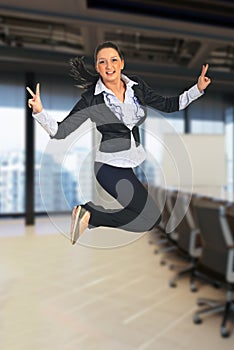 Victorious business woman jumping