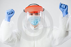 Victorious doctor or nurse in personal protective equipment
