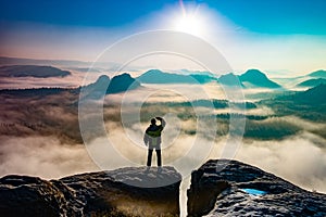 Victorious male person standing on mountain top