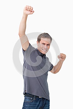 Victorious young man raising fist