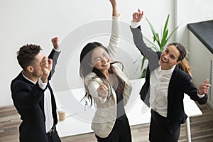 Victory dance concept, excited diverse coworkers celebrating bus