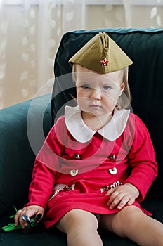 Victory Day Russia Baby girl in a military cap at home