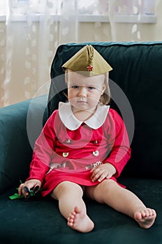 Victory Day Russia Baby girl in a military cap at home