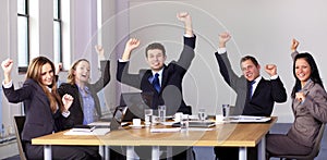 Victory gesture made by 5 business people