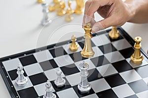 victory leader and success concept, business man playing take a checkmate figure another king with team on the chess board and