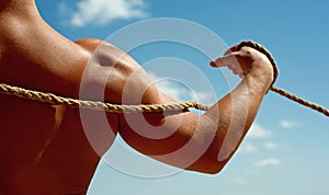 Victory over self. Test of muscular strength. Strong arm and shoulders tugging rope. Sport training. Physical strength