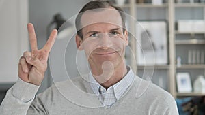 Victory Sign by Positive Middle Aged Man