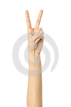 Victory sign. Woman hand gesturing isolated on white