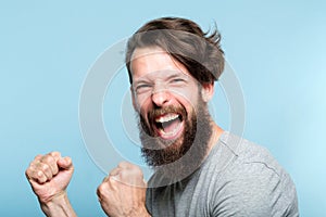 Victory success thrill winner excited agitated man photo