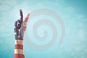 Victory symbol and American flag pattern on people`s hand with for USA  election day concept