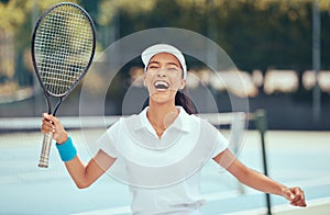 Victory, winner and tennis player woman celebrating with racket after winning a competition or tournament match at an
