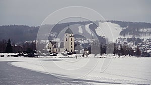 Rattvik kyrka on frozen lake Siljan in Dalarna in Sweden photo