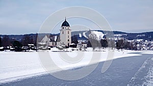 Rattvik kyrka on frozen lake Siljan in Dalarna in Sweden photo