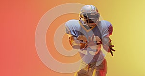 Video of african american american football player over yellow to orange background