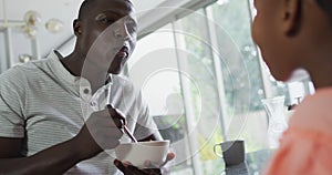 Video of african american father and daughter preparing breakfast