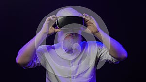 Video of an albino grandfather putting on a new vr set, isolated on a cool, unique background