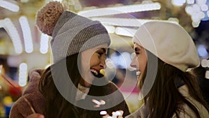 Video of attractive females with sparklers on Christmas market.