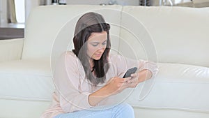 Video of brunette woman texting with her mobile phone