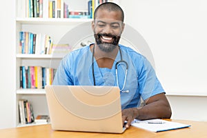 Video call of african american doctor with patient at computer