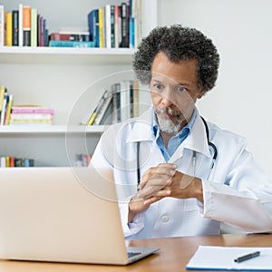 Video call of african american senior doctor