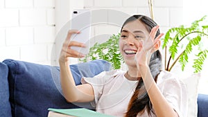 Video call conference, Happy girl having a video chat on mobile phone at home, Asian woman talking video call on a smartphone,