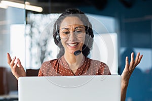 Video call online meeting with colleagues, Hispanic woman working inside modern office, businesswoman smiling and