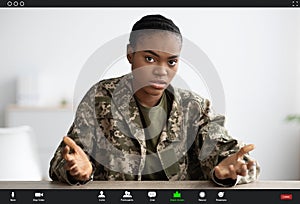 Video Call Screenshot. Serious Black Soldier Woman Talking And Gesturing At Camera photo