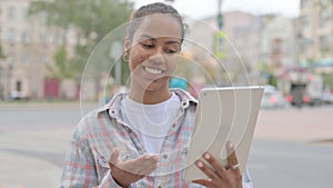 Video Call on Tablet by African Woman Outdoor