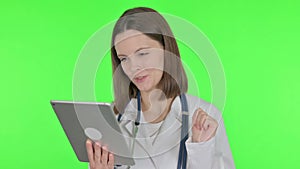 Video Call on Tablet by Female Doctor on Green Background