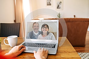 Video call. Woman talks online with her parents