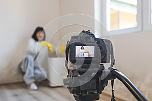 Video camera filming how woman using dehumidifier cleaning and drying air next to a bad mildew and fungus growth on an interior