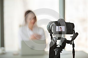 Video camera filming live training of successful business coach