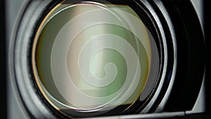 Video camera lens, showing zoom and glare, turns