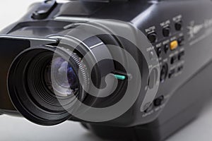 The video camera with the microphone isolated on white, in concept of technology, entertainment. Retro camcorder