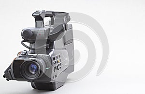 The video camera with the microphone isolated on white, in concept of technology, entertainment. Retro camcorder