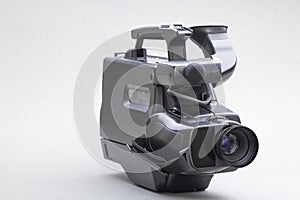 Video camera with the microphone isolated on white, in concept of technology, entertainment. Retro camcorder