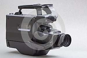 Video camera with the microphone isolated on white, in concept of technology, entertainment. Retro camcorder