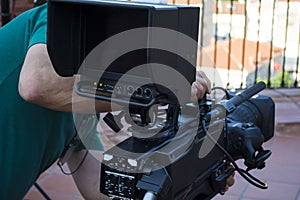 Video camera operator working with his equipment