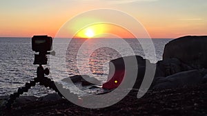 Video Camera Set Up on Tripod Filming Time Lapse of Sunset over the Andaman Sea, Thailand. HD.