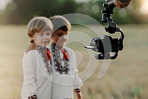 Video camera on stabilizer.Man operator working with kids.Professional equipment