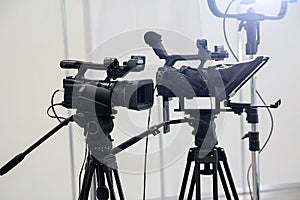 Video cameras on tripods and studio lights pavilion