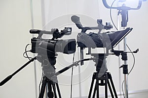 Video cameras on tripods and studio lights pavilion photo