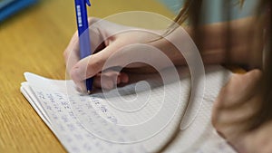 A video capturing a child diligently doing homework at a desk