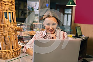 Beautiful prosperous businesswoman having video chat with her partner